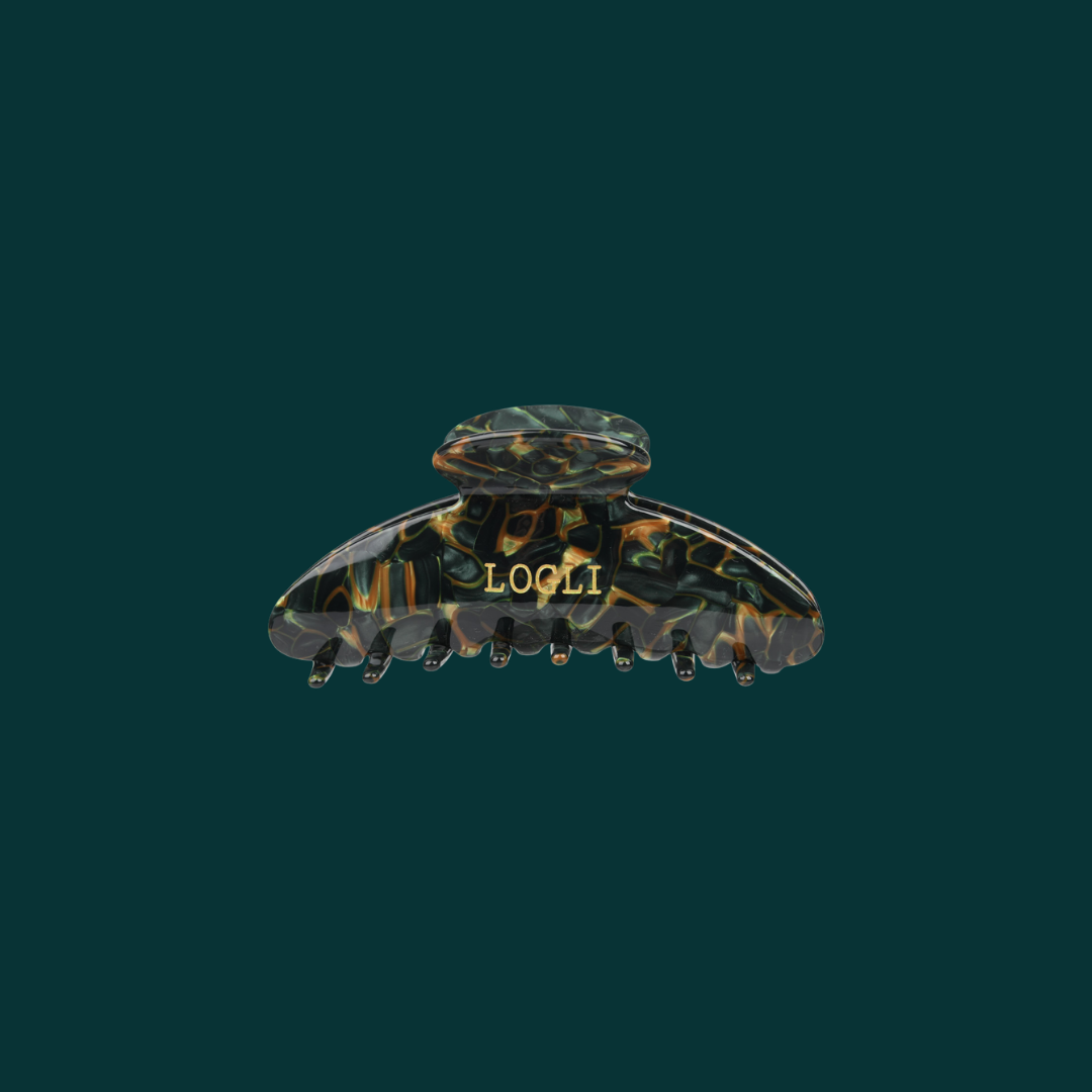 Tortoiseshell patterned hair clip with 'LOOLI' branding on a dark green background
