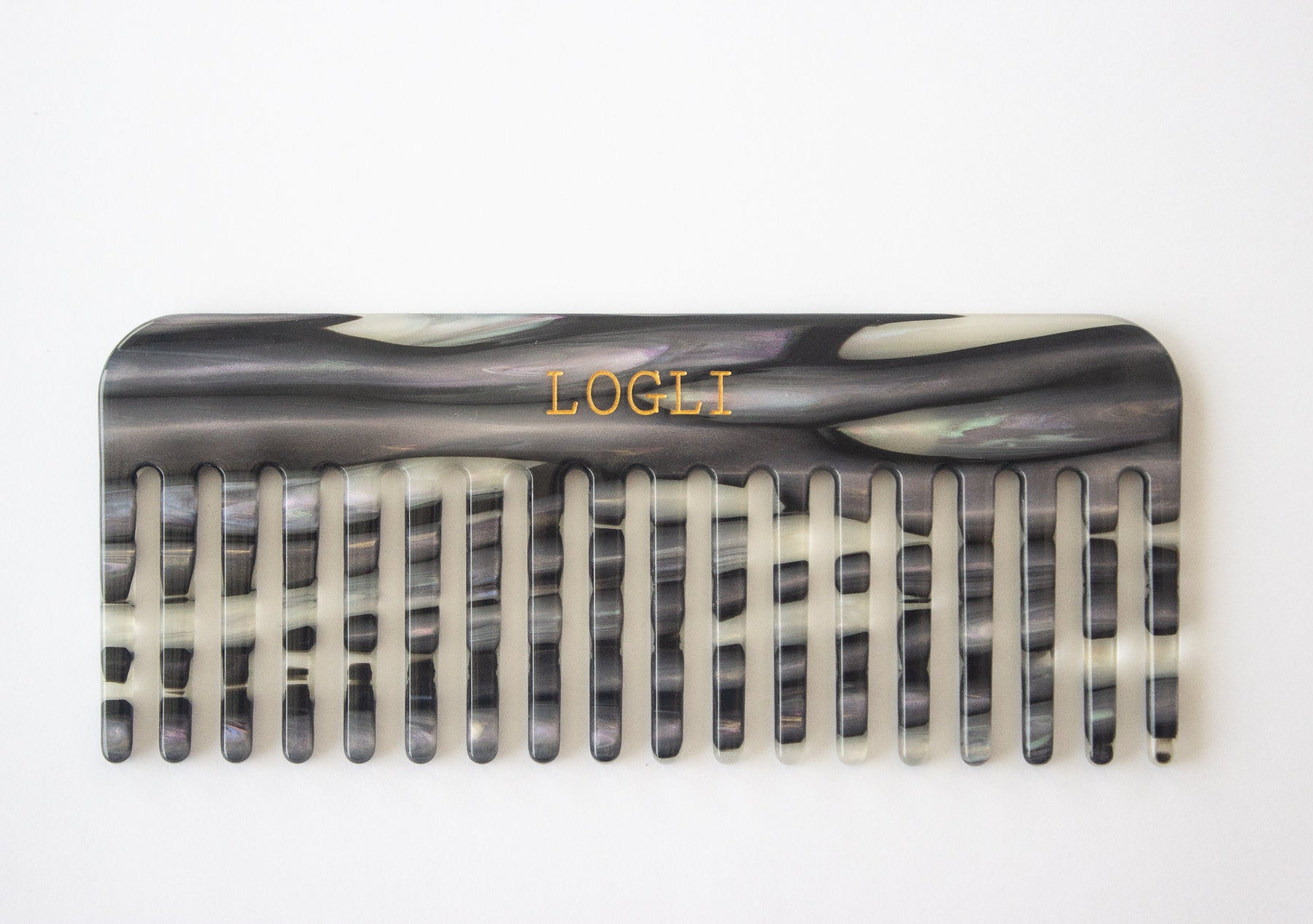 Zebra patterned comb with 'LOGLI' branding on a white background