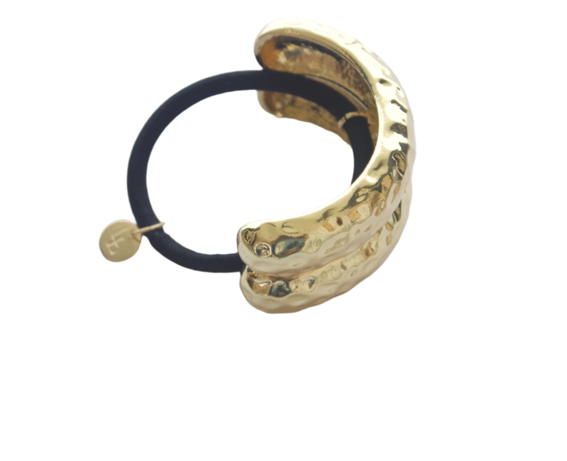 Gold hair tie with black elastic on a light gray background