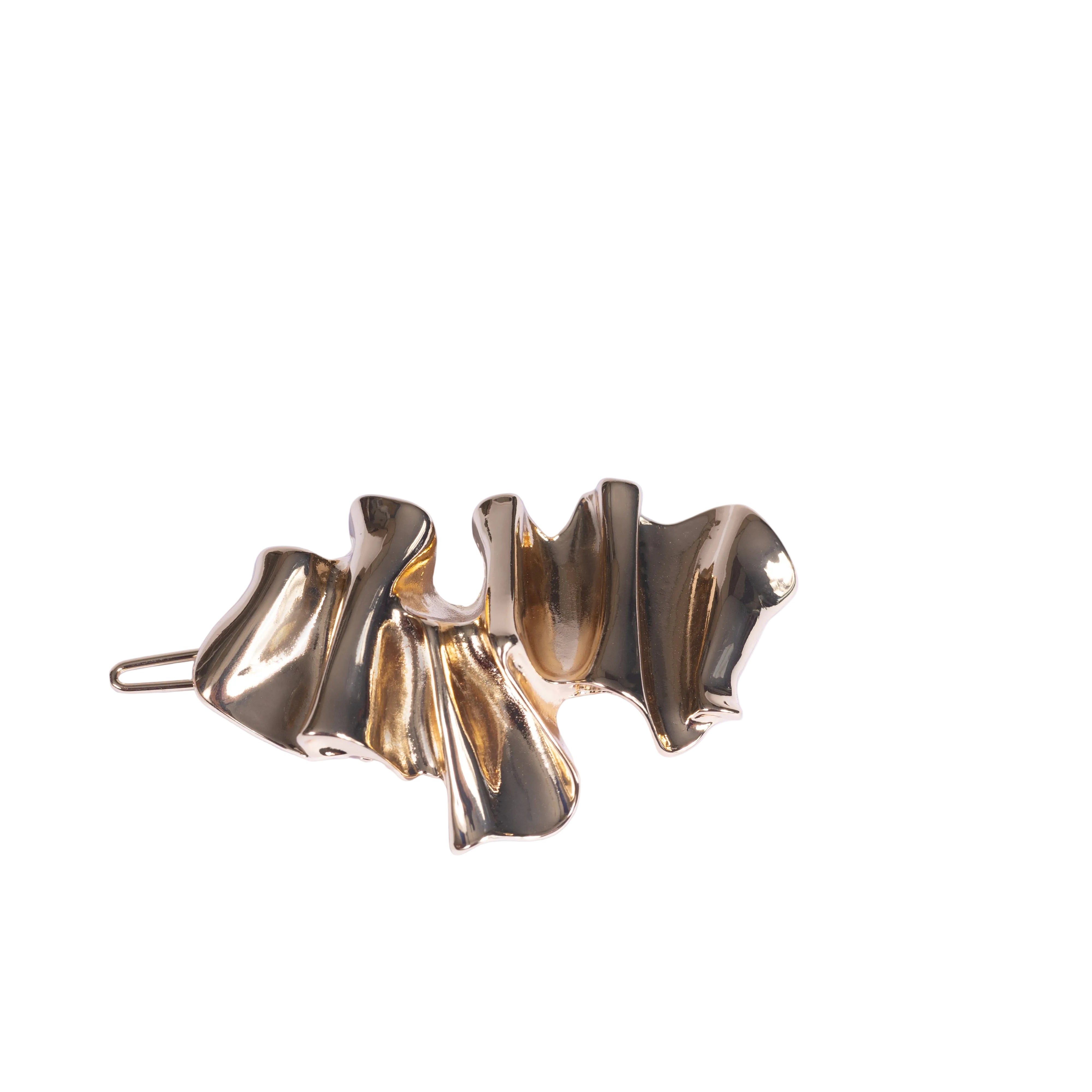 Gold hair clip on a white background