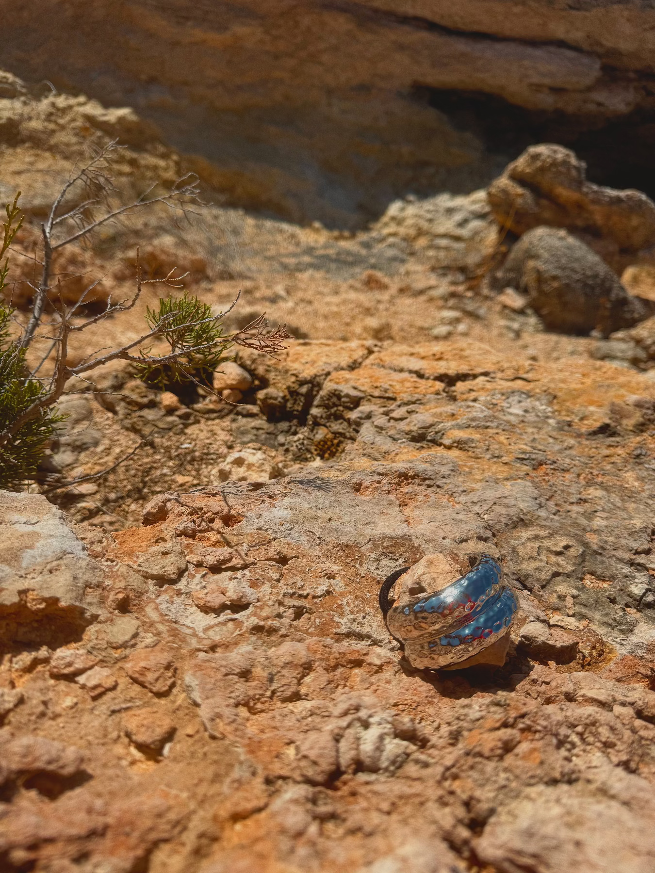 Decorative metal hair band on a rocky surface