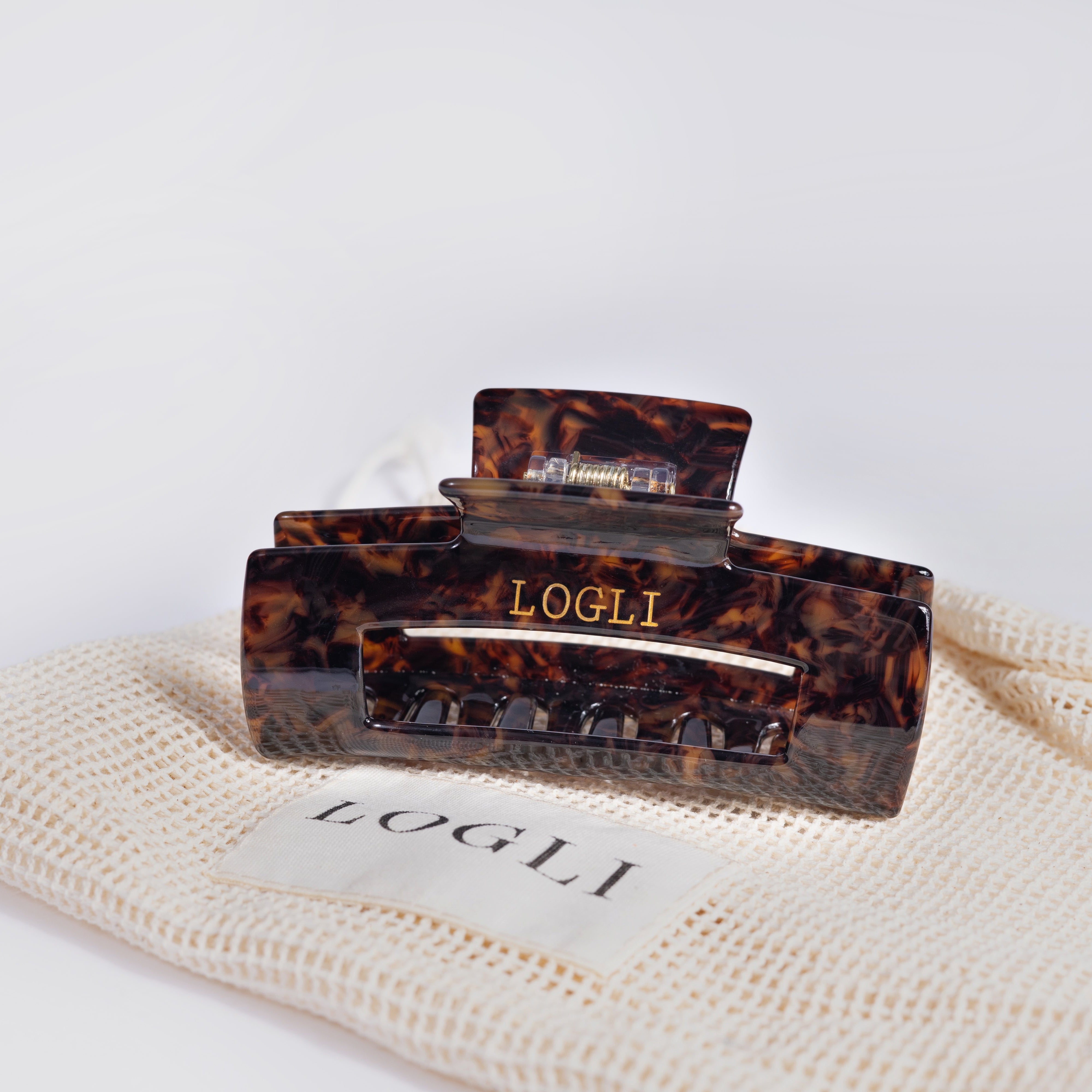 Tortoiseshell hair clip with 'LOGLI' branding on a white background