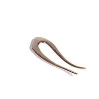 Gold hairpin on a white background