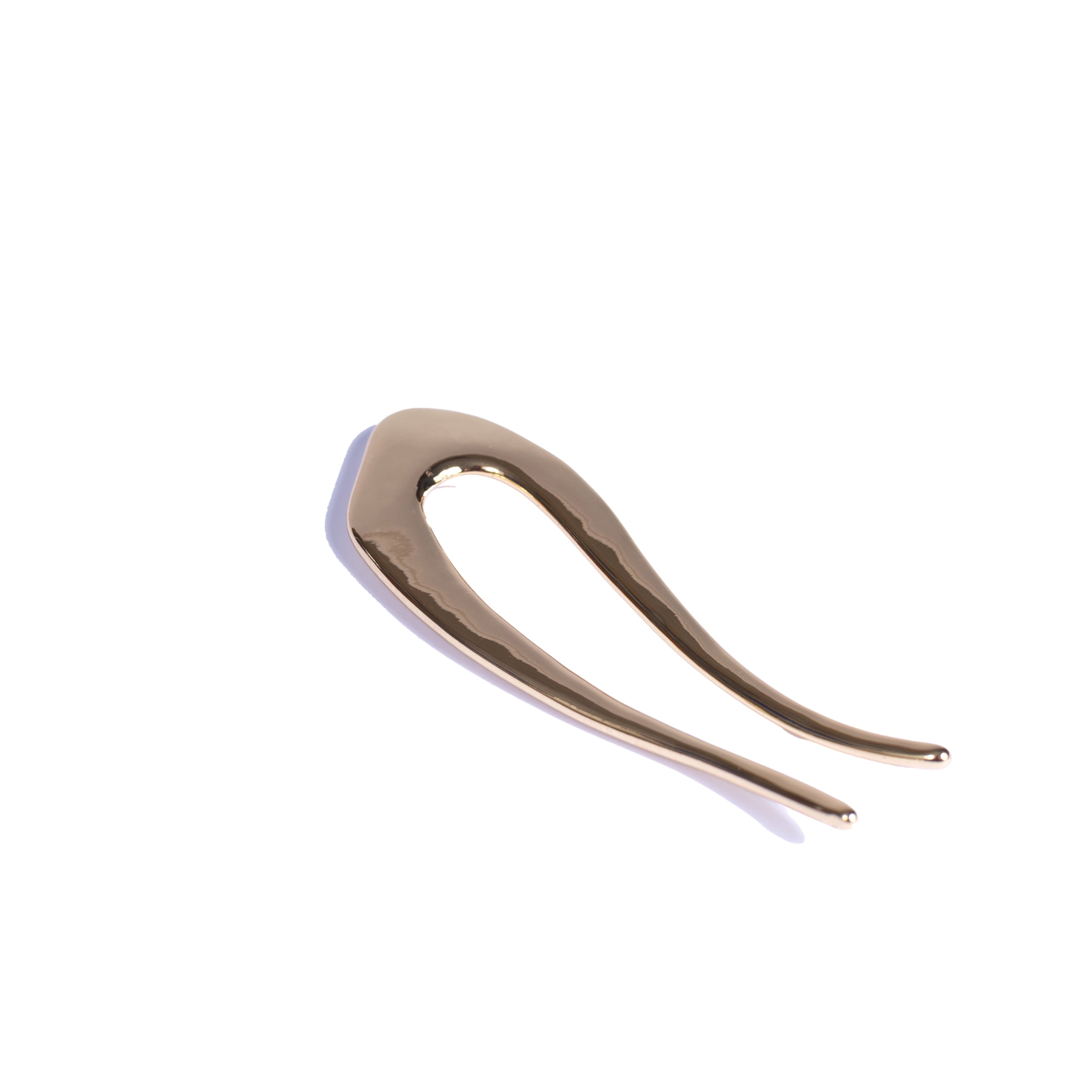 Gold hairpin on a white background